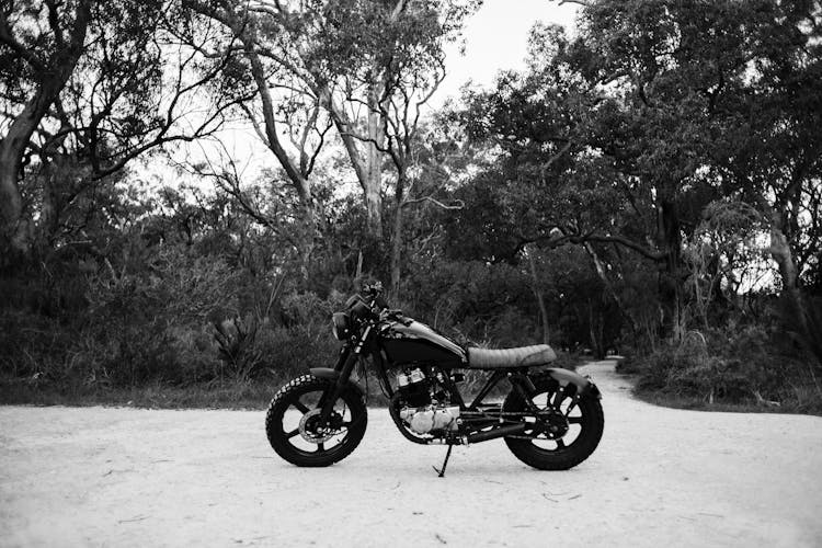 Motorbike Parked On Road Near Woods