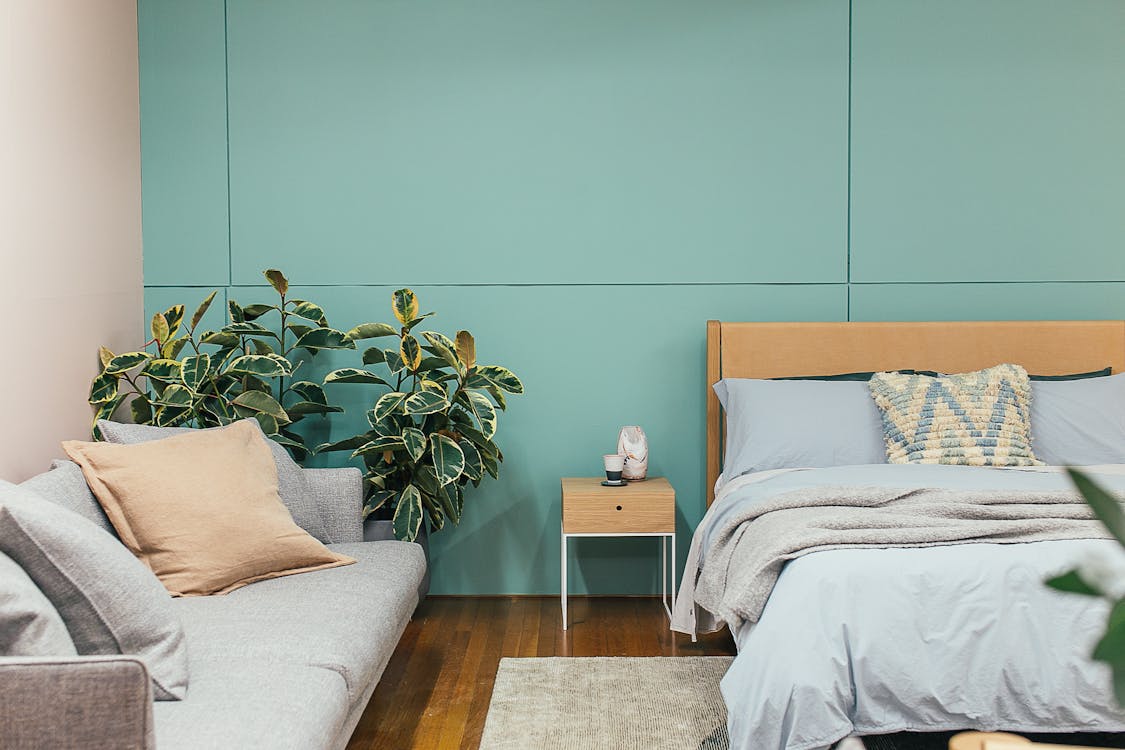 Cozy bedroom with minimalist furniture and green and gray walls