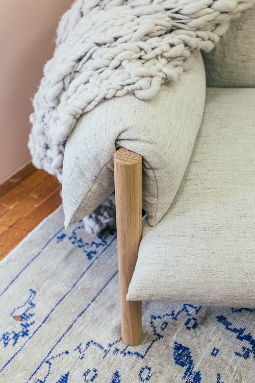 Detail of soft armchair on rug