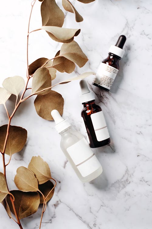 Bottles with Exfoliating Serum on a Marble Counter