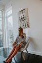 Stylish woman chilling in chair in bright hall