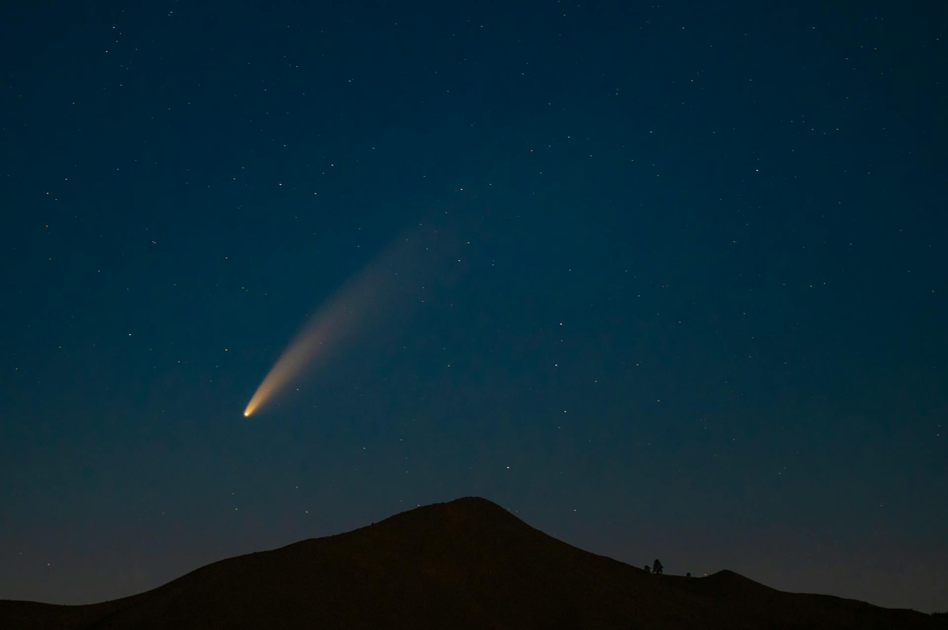 Night Shot of a Mountain and Comet in Sky