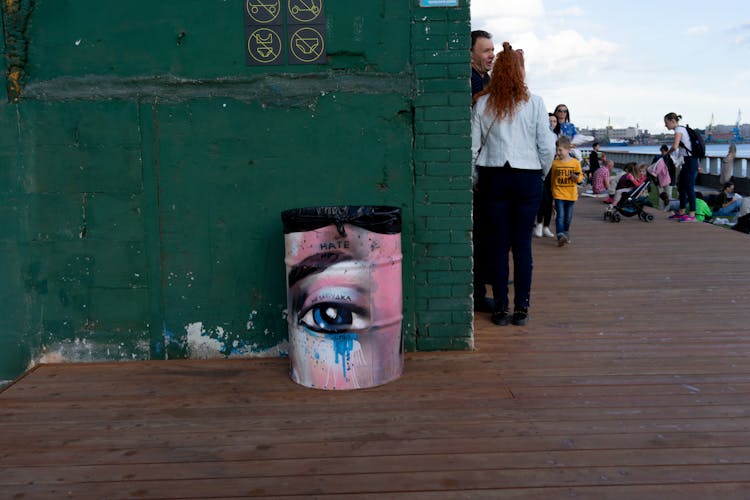 Crowded Wooden Terrace With Painted Bucket