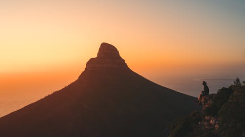 Brown Mountain Under Orange Sky