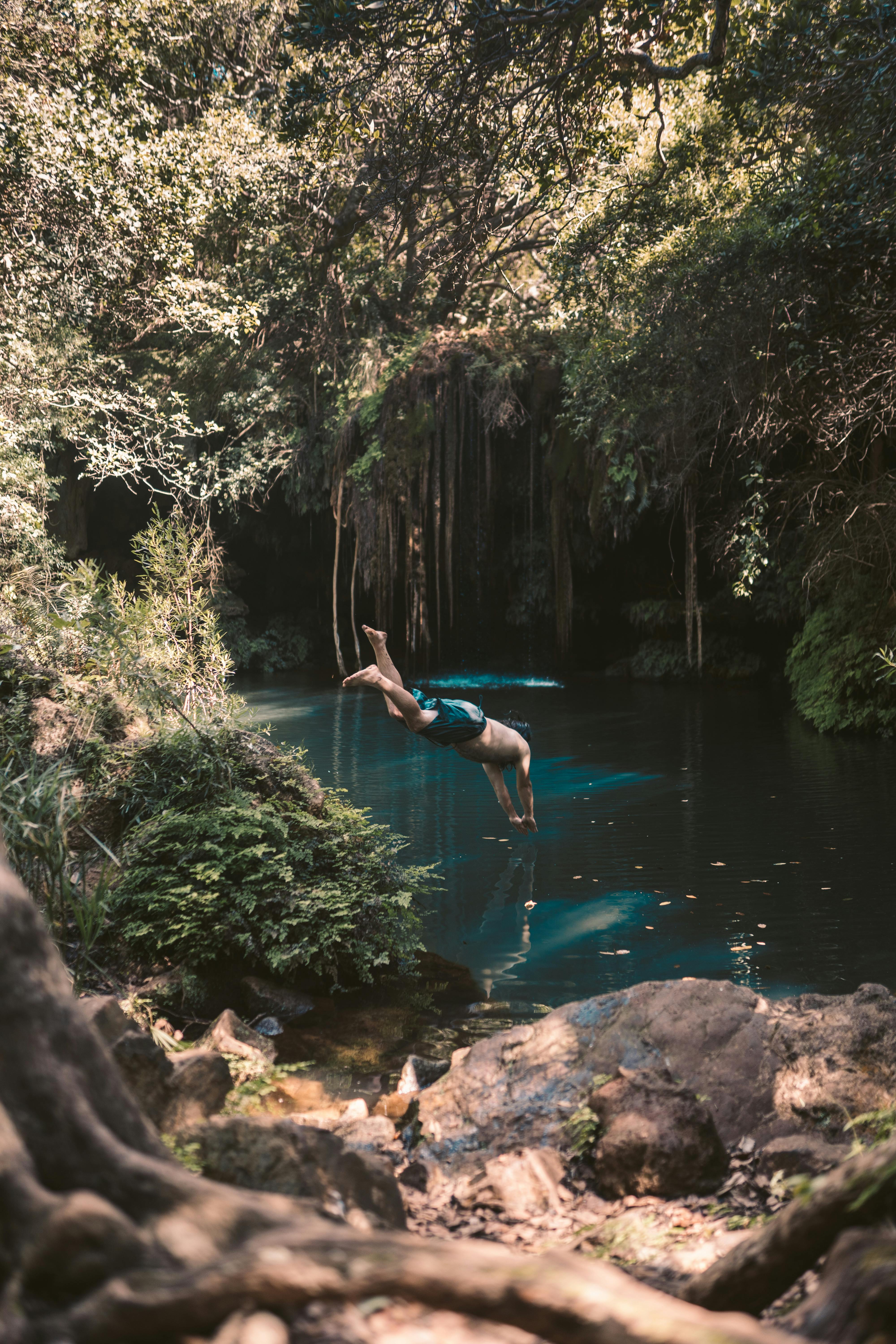 Woman in Blue Bikini Jumping Into Water · Free Stock Photo