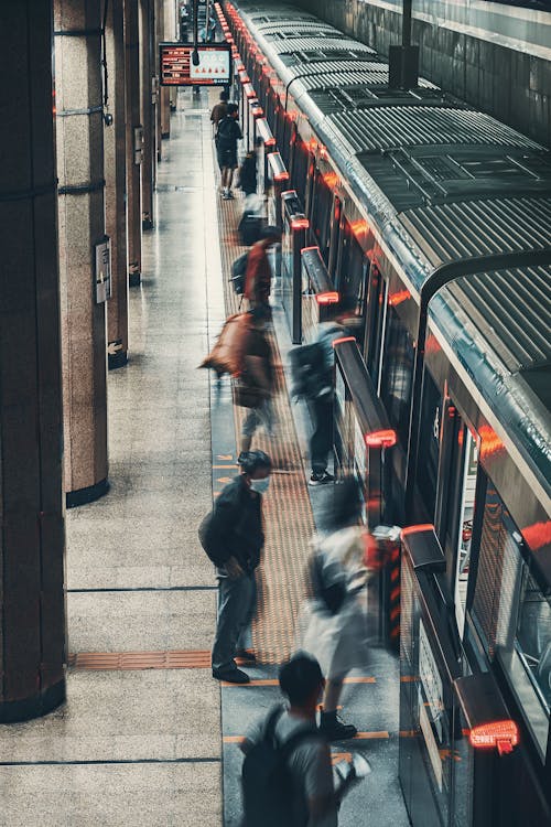 Commuters Standing on Train Platform 