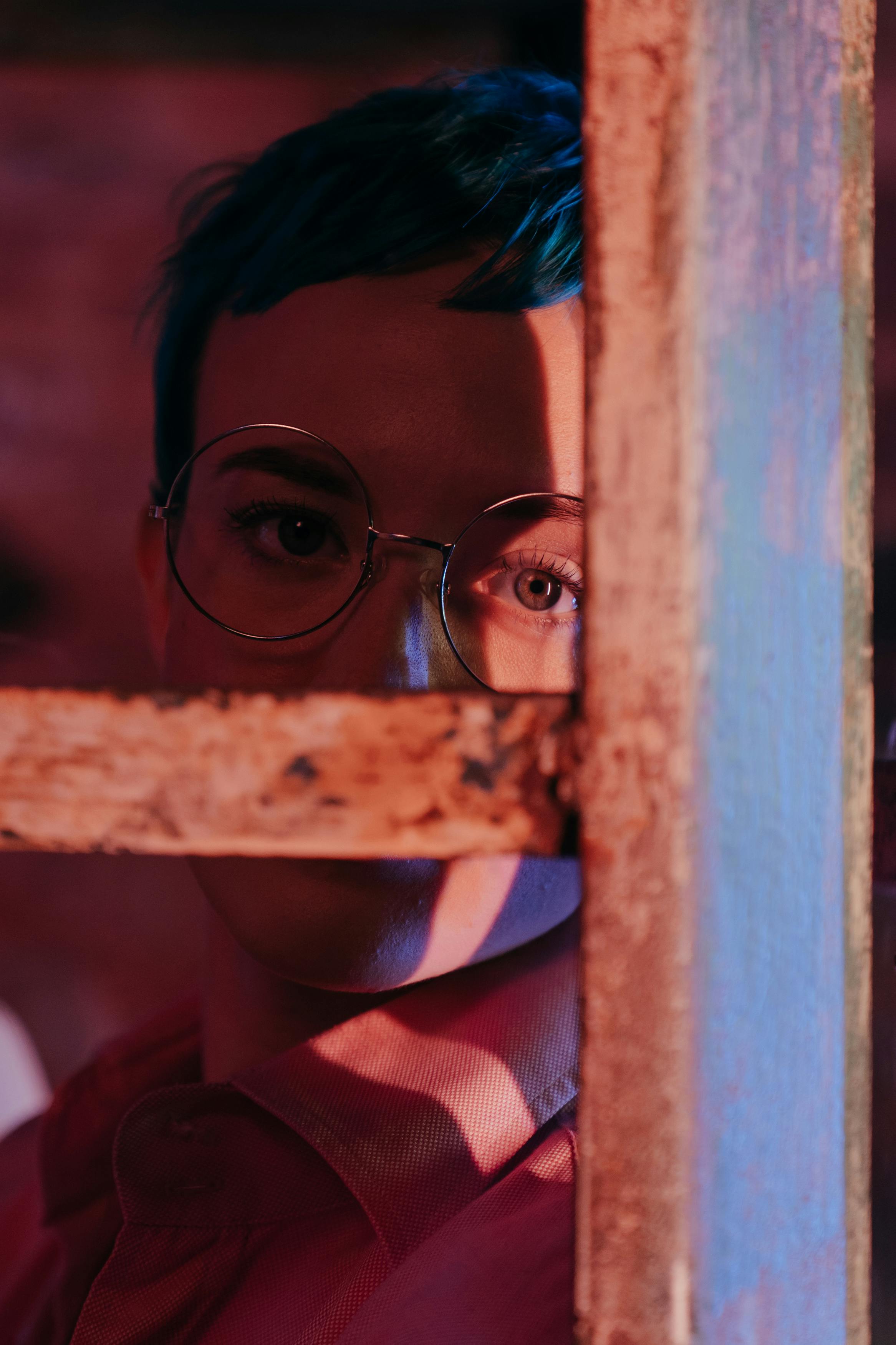 woman in red and white stripe shirt wearing black framed eyeglasses