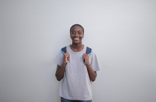 Photo of a Woman in a Gray Shirt Smiling