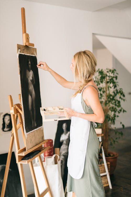 A Woman Drawing while Using a Chalk