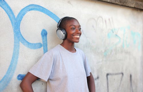 A Person Smiling while Wearing Headphones