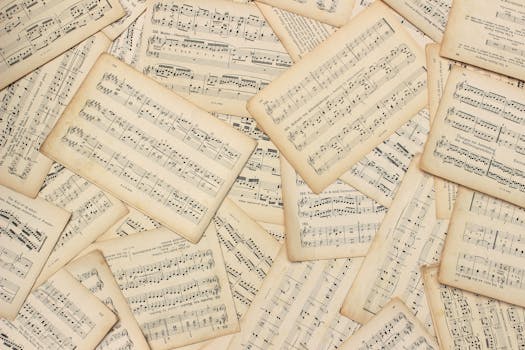 An artistic flat lay of vintage music sheets with a classic touch.