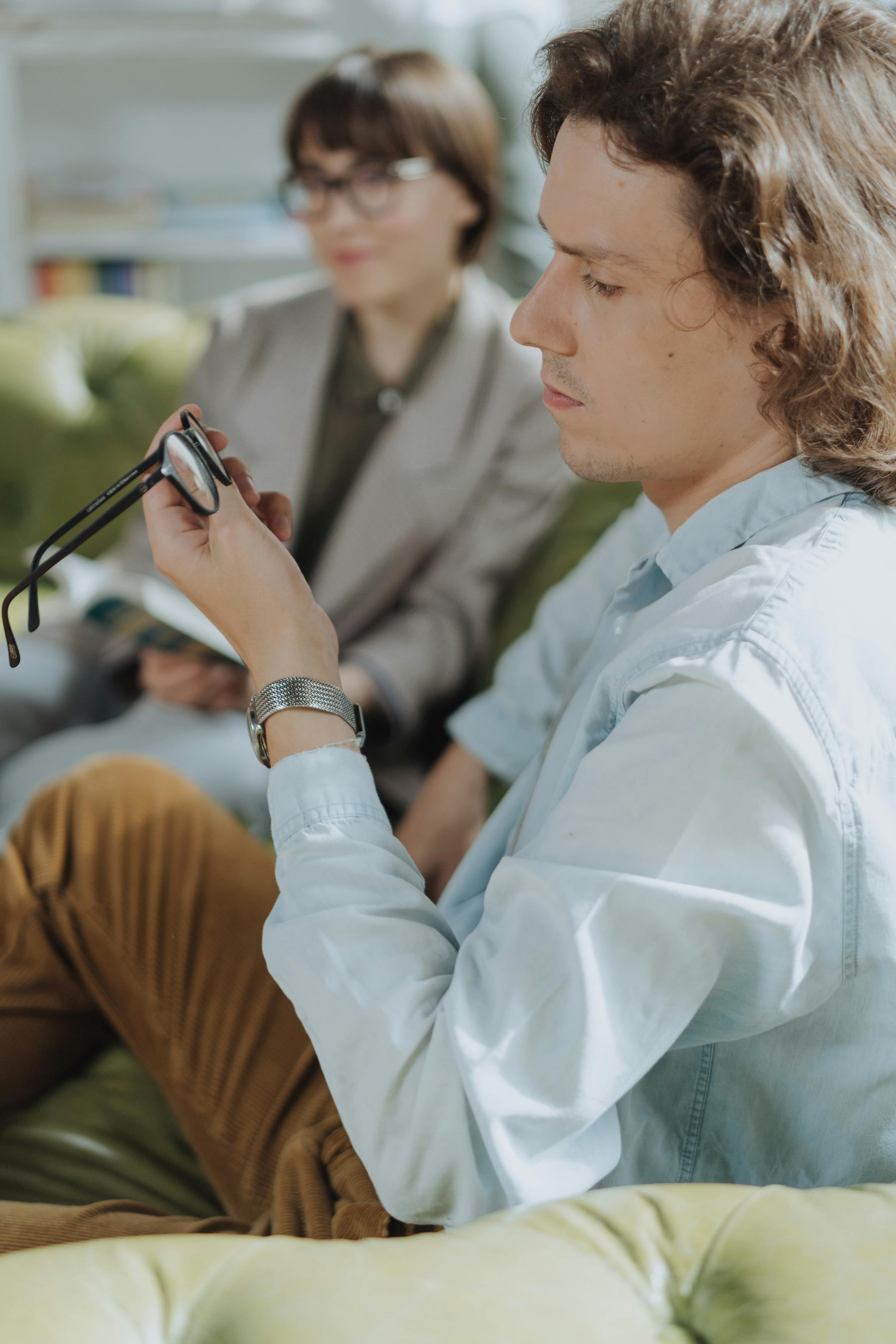 woman in white dress shirt holding smartphone