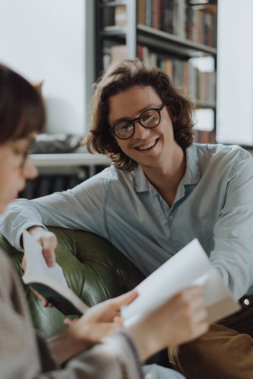 Woman in Gray Dress Shirt Holding White Paper