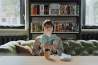 Boy in Gray Sweater Sitting on Couch