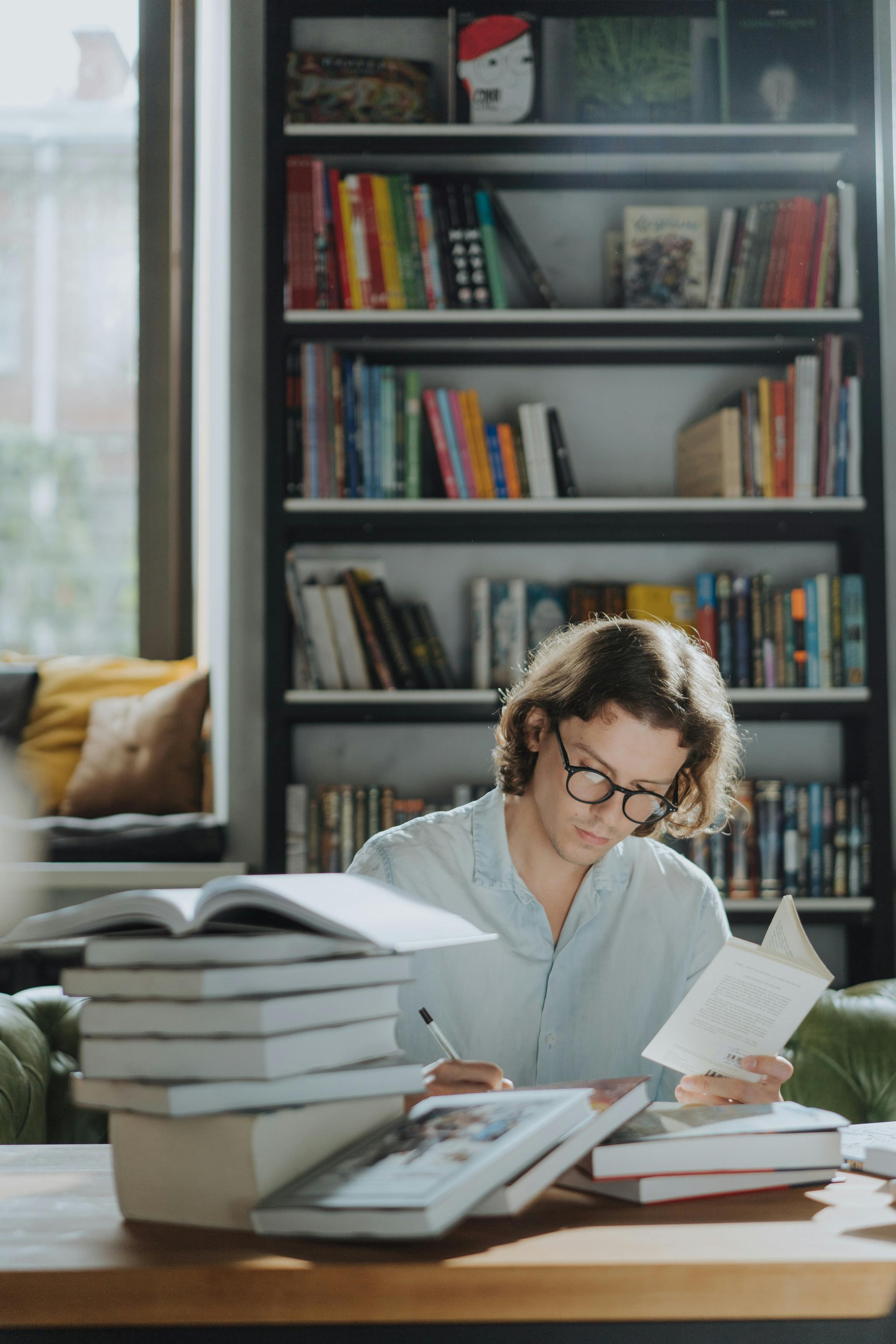 man in white dress shirt reading book