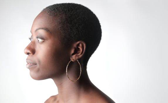 Close-up side profile of an African American woman wearing a hoop earring.