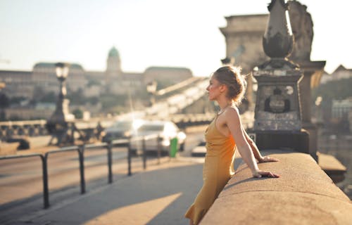 A Side View of a Woman Wearing Yellow Dress