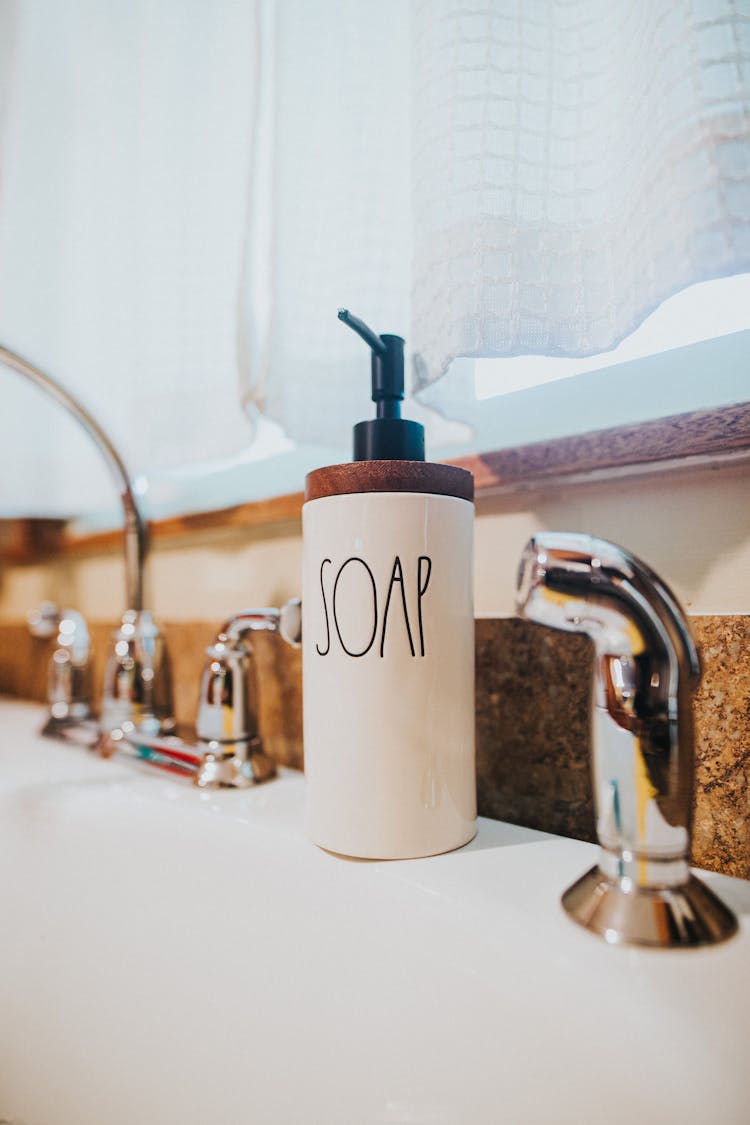 Ceramic Soap Dispenser Placed On Wash Basin