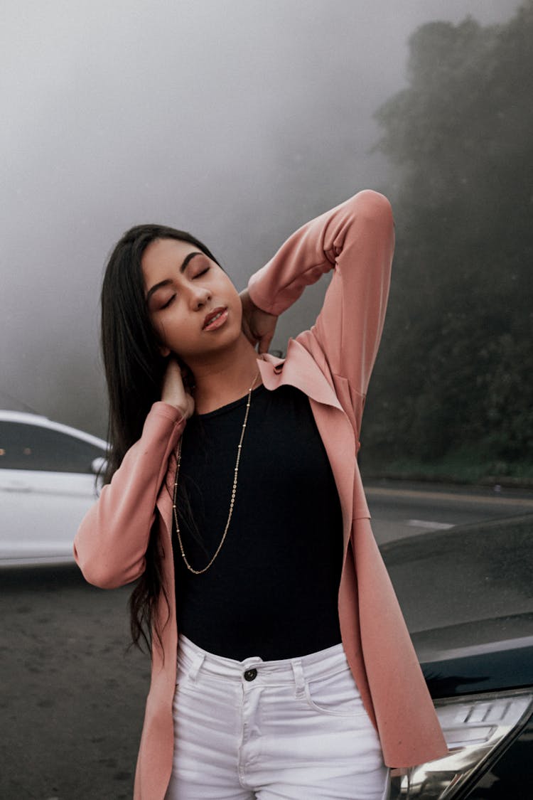 A Woman Wearing A Pink Cardigan