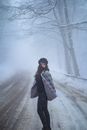 A Woman in Fur Jacket while Standing on a Snow Covered Ground