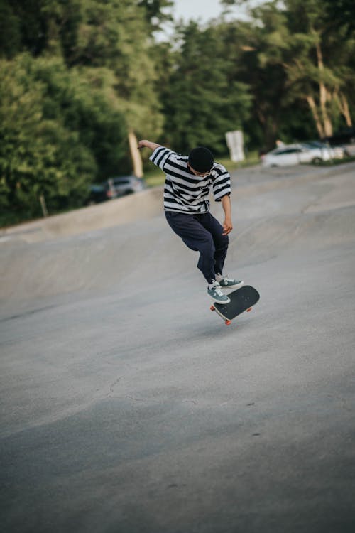 Young man riding skateboard and doing trick
