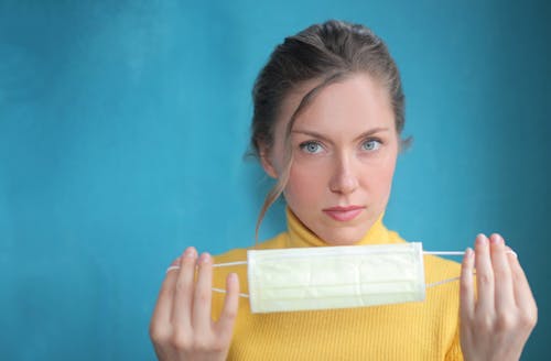 Woman Holding Face Mask