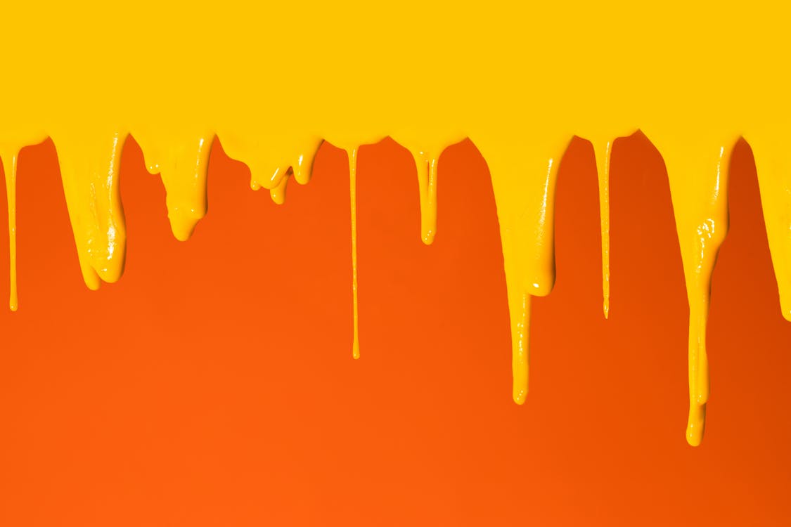 Yellow Paint Dripping on Orange Surface · Free Stock Photo