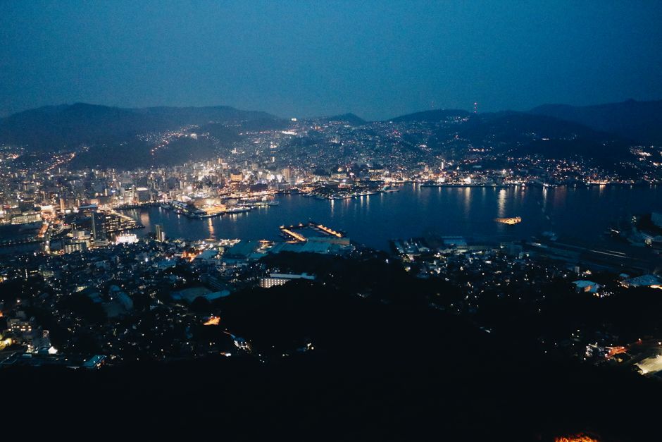 Spectacular aerial cityscape with illuminated harbor at night, showcasing urban beauty.