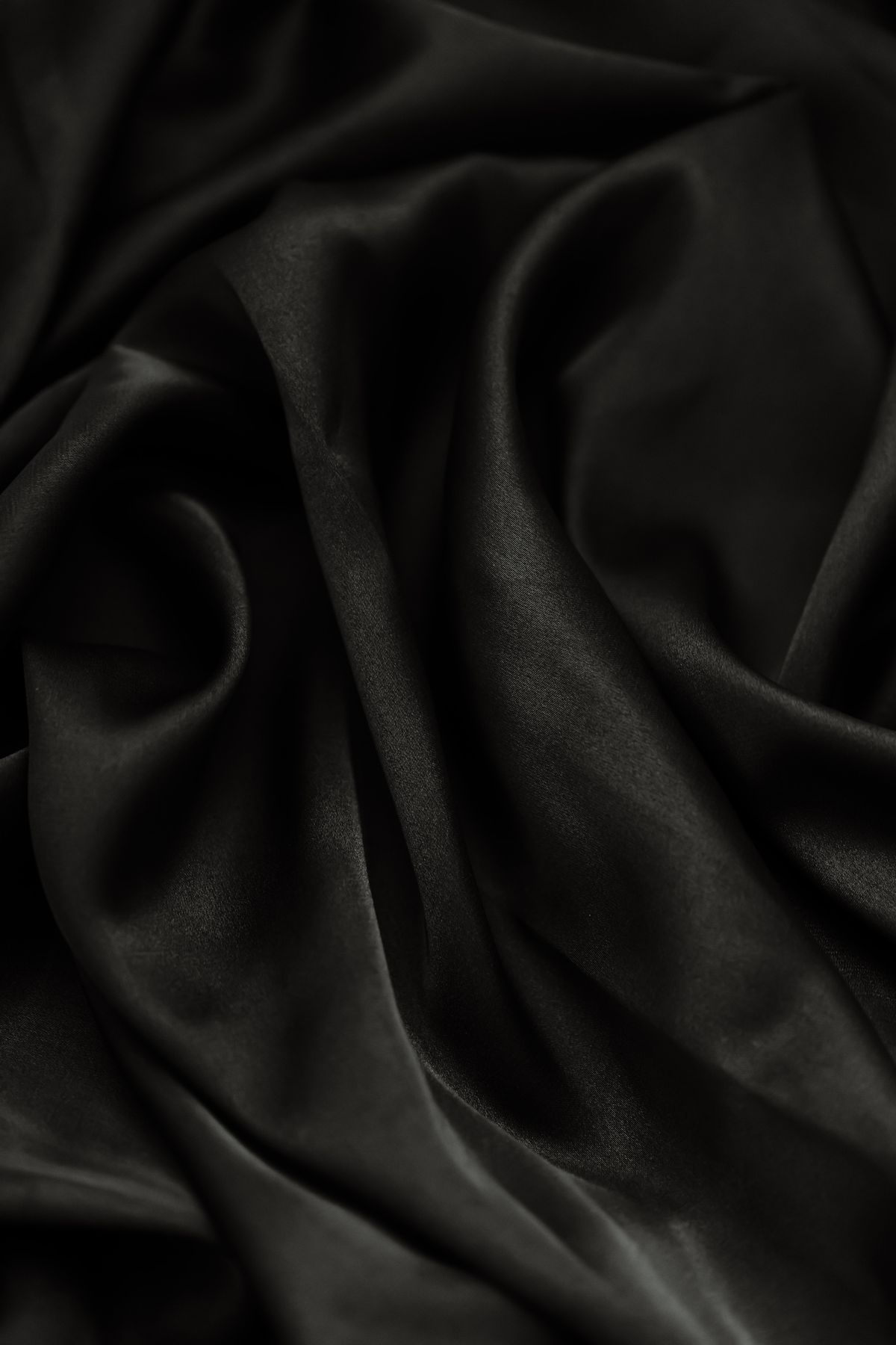 Close-up of flowing black maxi gown fabric and draping