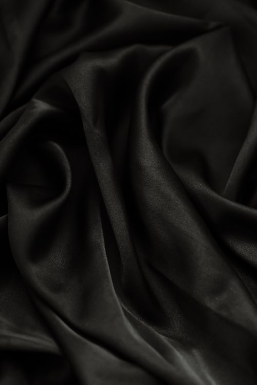 Free Close-up of smooth rippled black fabric, perfect for backgrounds or textiles. Stock Photo