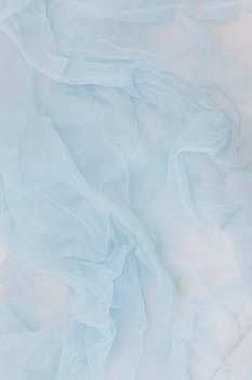 A soft and elegant rippled baby blue fabric texture, perfect for backgrounds or wallpapers.