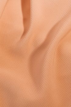 Close-up of a soft pastel fabric with rippled texture, perfect for background use.