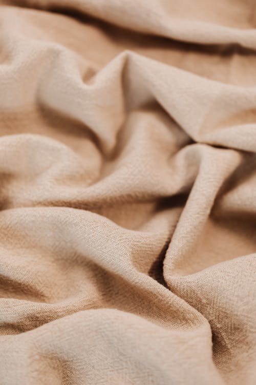 Close-Up Photo of Beige Textile