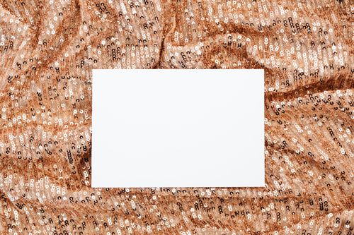 Free A blank card on a sparkling sequin background, ideal for mockups with a festive touch. Stock Photo