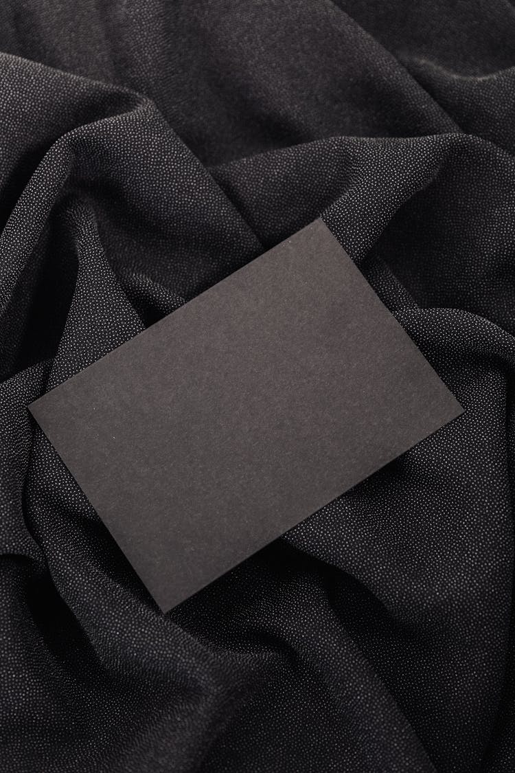Black Paper On Top Of A Black Fabric