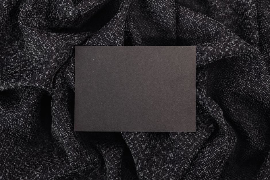 장애인 복지카드 혜택과 신청 절차, 사용 꿀팁 10 A black card placed on luxurious black textured fabric, perfect for mockups.