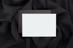 Blank card on black cloth, by Kaboompics on Pexels