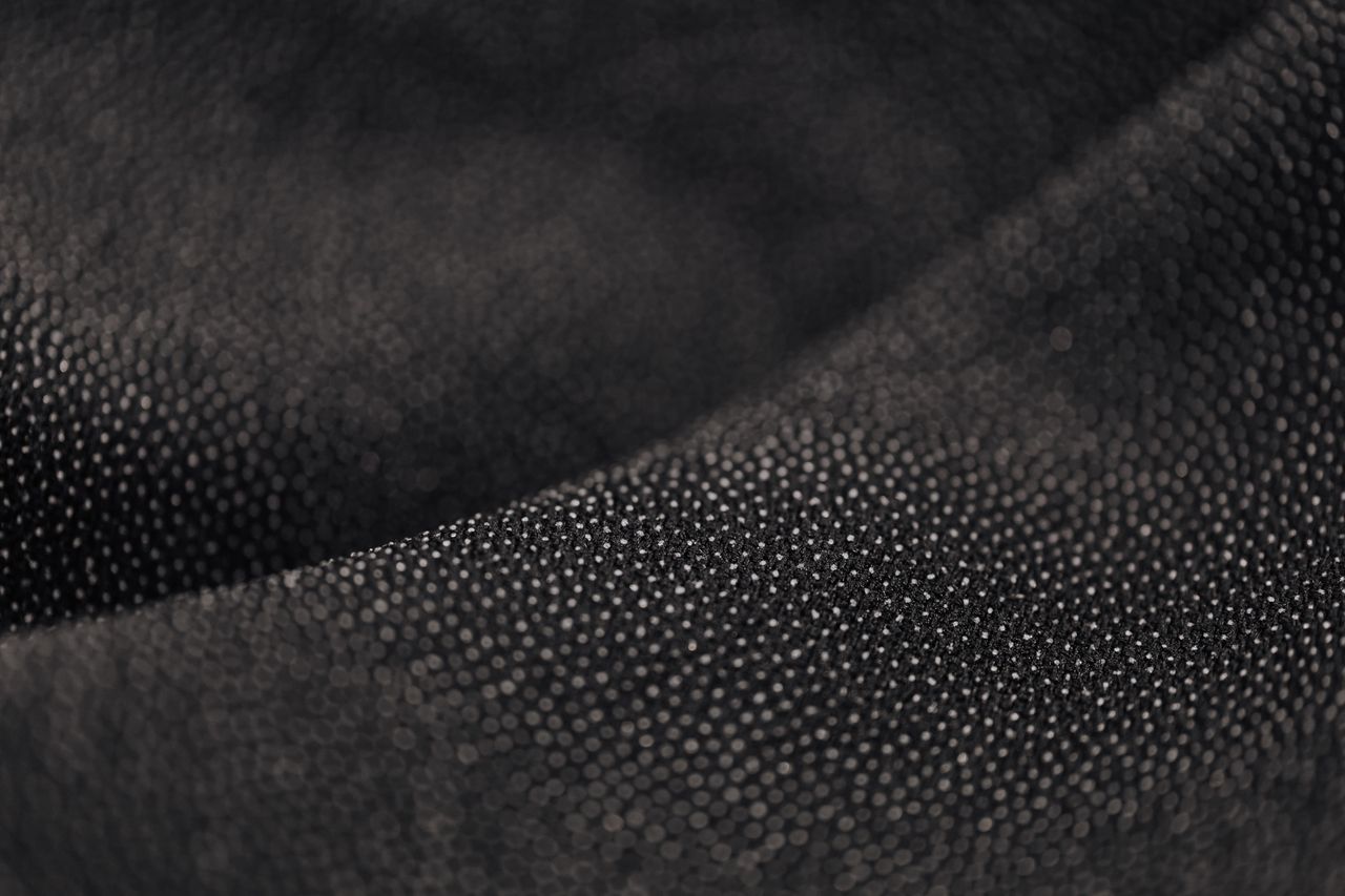 macro shot of a black dotted fabric texture showcasing intricate mater