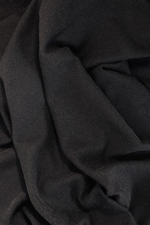 Free Close-up of elegant black fabric showcasing intricate textures and drapery folds. Stock Photo