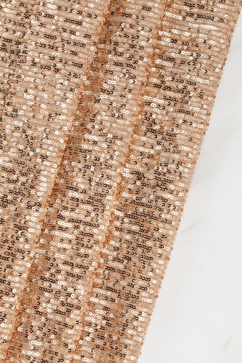 Brown and White Sequence Design on Brown Fabric