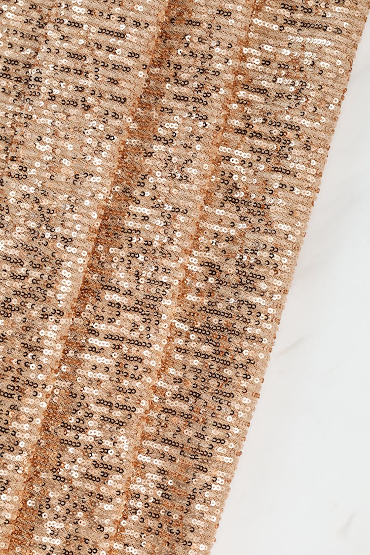 Brown And White Sequence Design On Brown Fabric