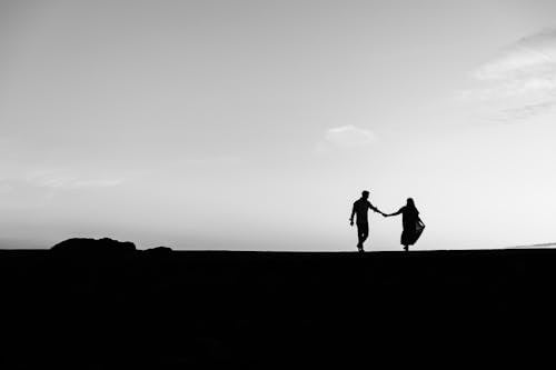 Free Silhouette of 2 Person Standing on Hill Stock Photo