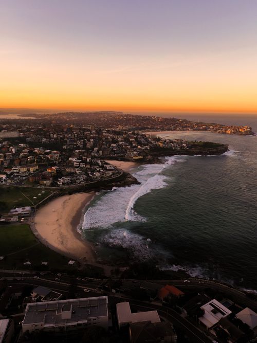 Free Stunning aerial view of Bronte Beach in Sydney at sunset, showcasing the vibrant coastline and urban landscape. Stock Photo