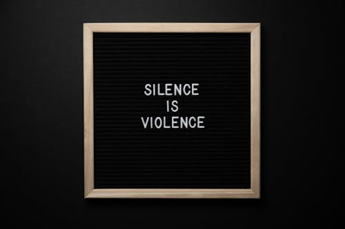 Blackboard with Silence Is Violence title on black background