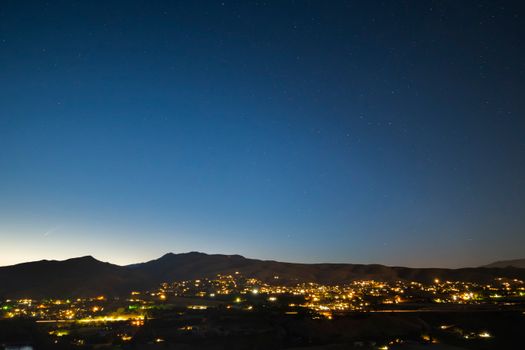 Explore the serene night view of Wenatchee's skyline, set against a clear, starry sky.