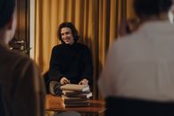 Man in Black Sweater Sitting on Chair