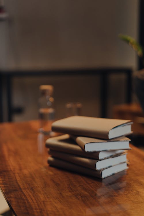Free Stack of Books Placed on Wooden Table Stock Photo