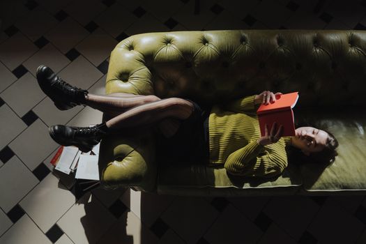 Man in Black T-shirt Sitting on Brown Leather Sofa