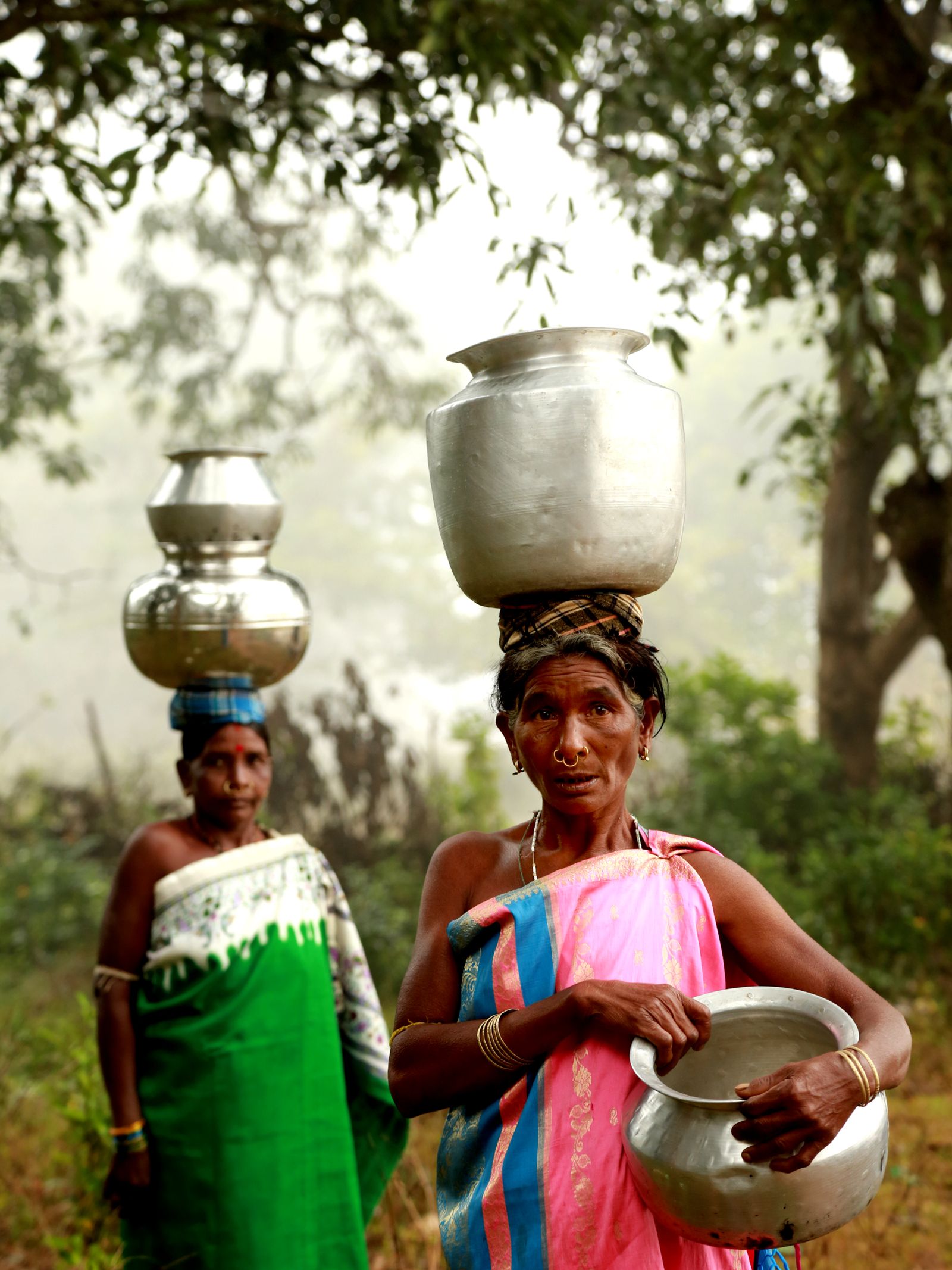 Rural Indian women carrying provisions in a village