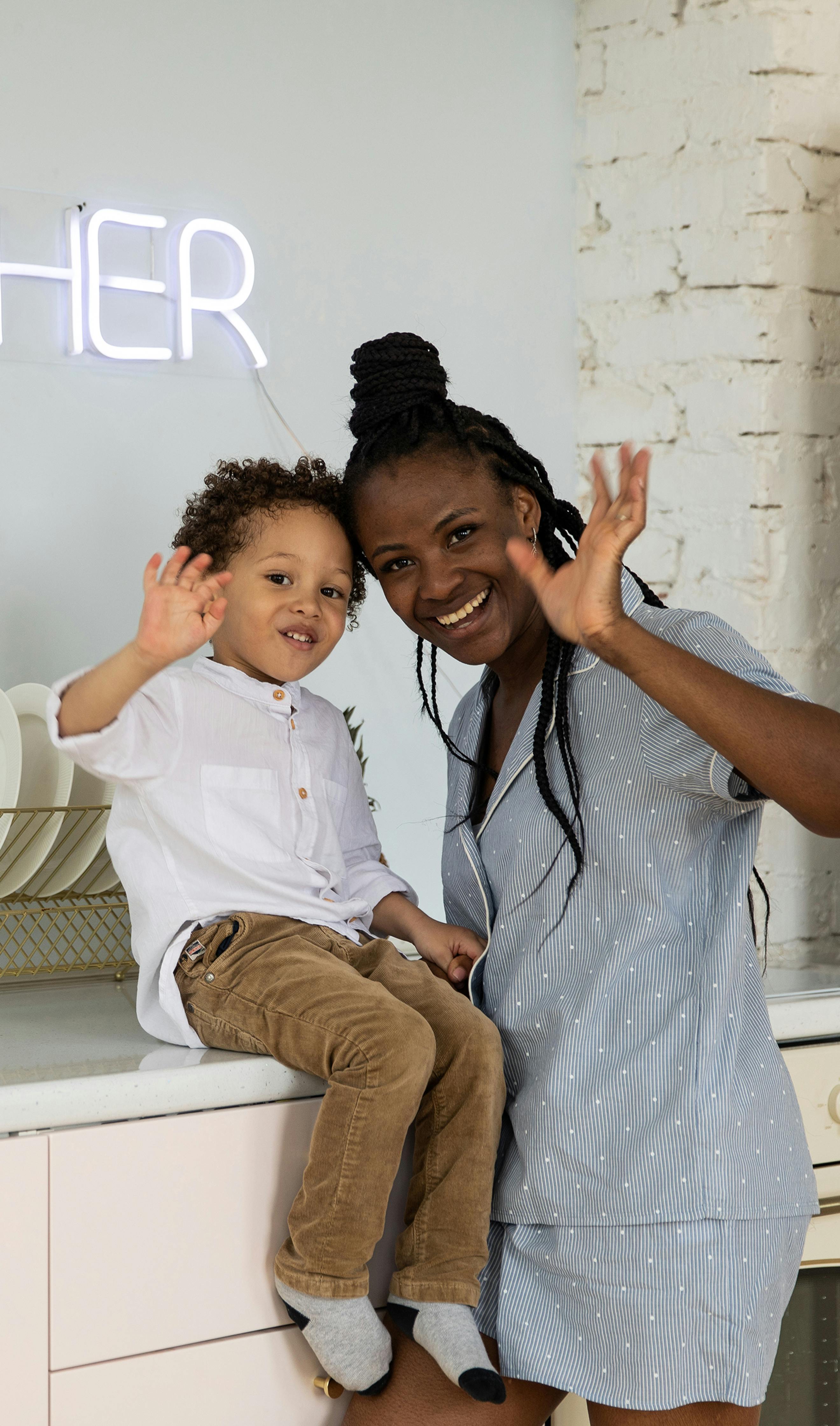 a woman and a boy waving